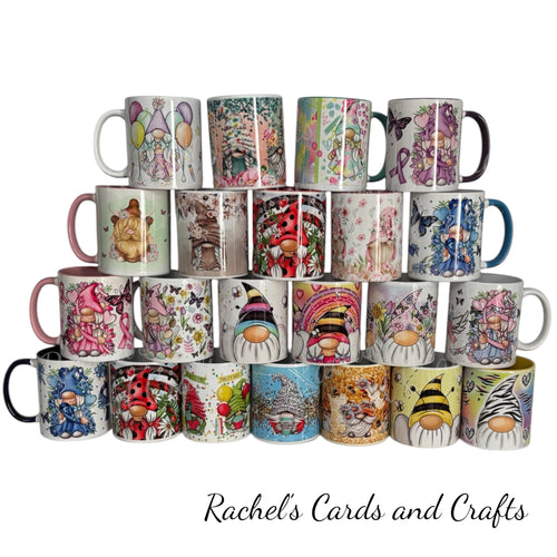 A collection of 24 ceramic mugs with various colorful gnome illustrations, arranged in a pyramid stack on a white background with the text 'Rachel's Cards and Crafts' below.